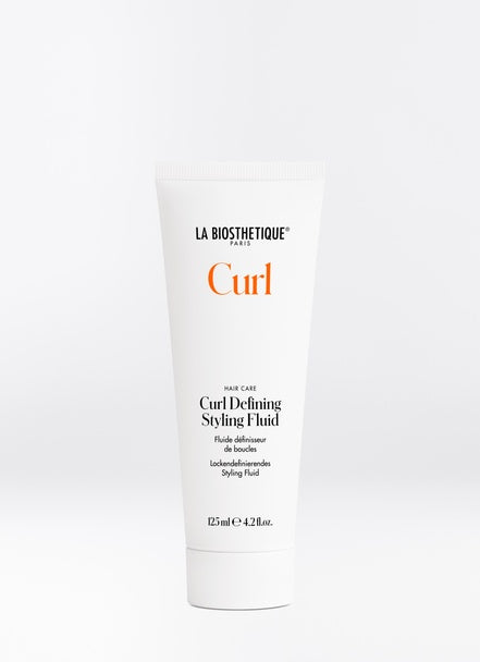 Curl Defining Styling Fluid tames stubborn curls and keeps them shiny and conditioned all day long. Improves elasticity and bounce, increase durability and provide weightless hydration. Shop online or in store at Shampoo Hair Bar in Victoria, BC.