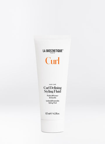 Curl Defining Styling Fluid tames stubborn curls and keeps them shiny and conditioned all day long. Improves elasticity and bounce, increase durability and provide weightless hydration. Shop online or in store at Shampoo Hair Bar in Victoria, BC.