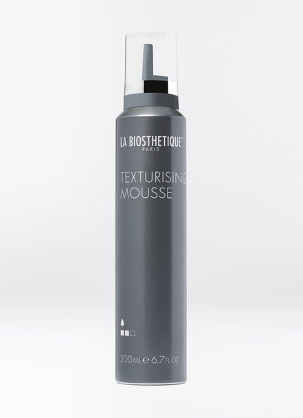 This mousse gives your hairstyle textured body, grip, and a soft matte finish. Despite its strong hold, Texturising Mousse allows a silky smooth blowdry and is easily brushable without leaving any residue. Shop online or in store at Shampoo Hair Bar in Victoria, BC.